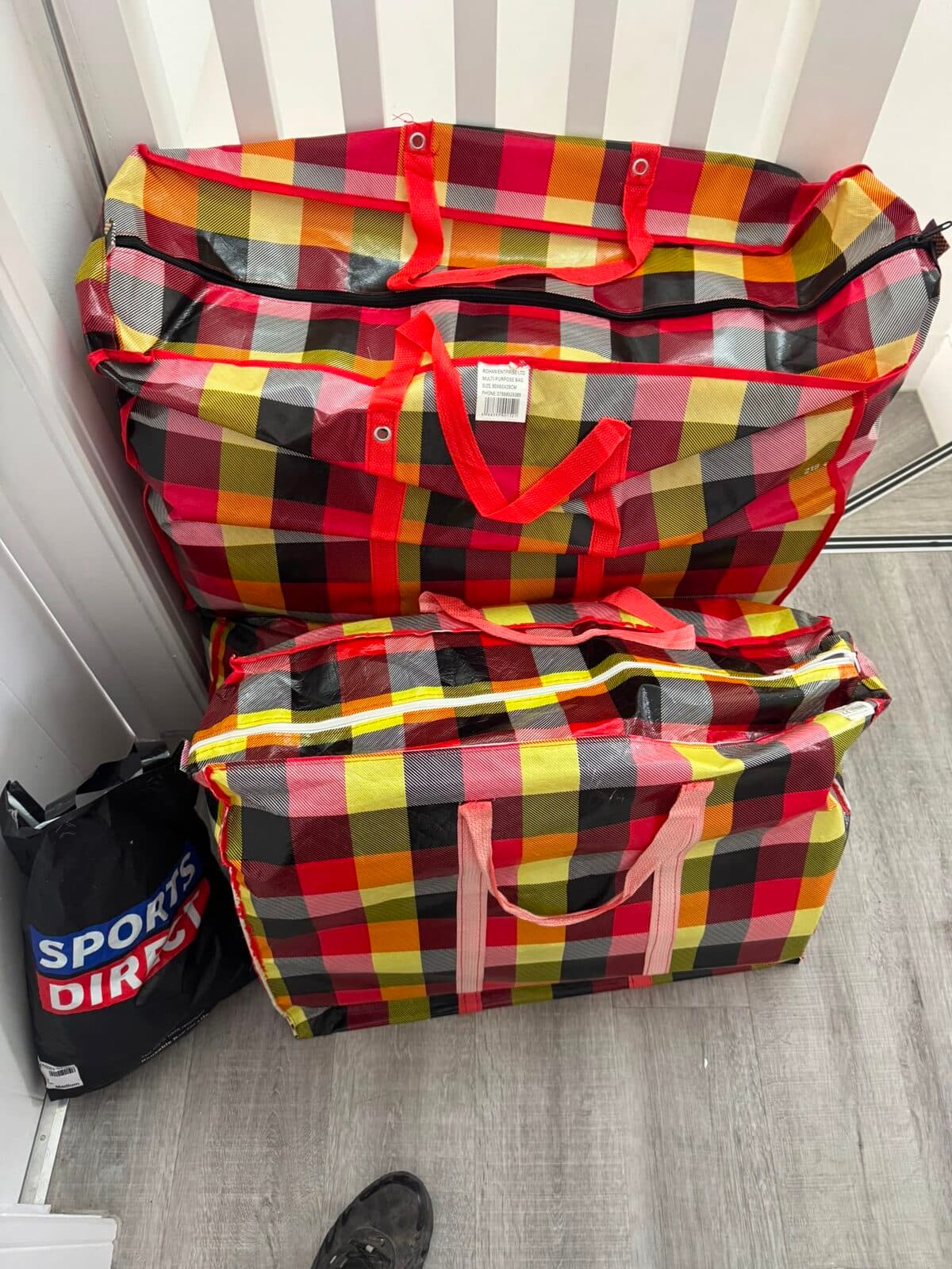 Bedding and soft furnishings packed into large moving bags during the Uxbridge house clearance
