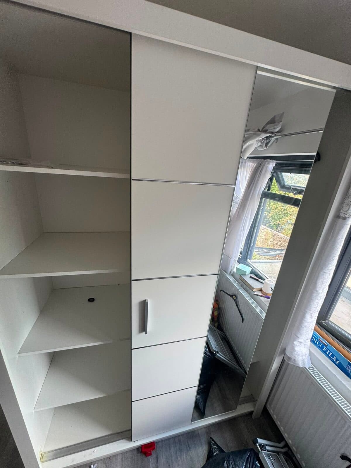 Wardrobe carcass and shelving stripped back before removal from the Uxbridge bedroom