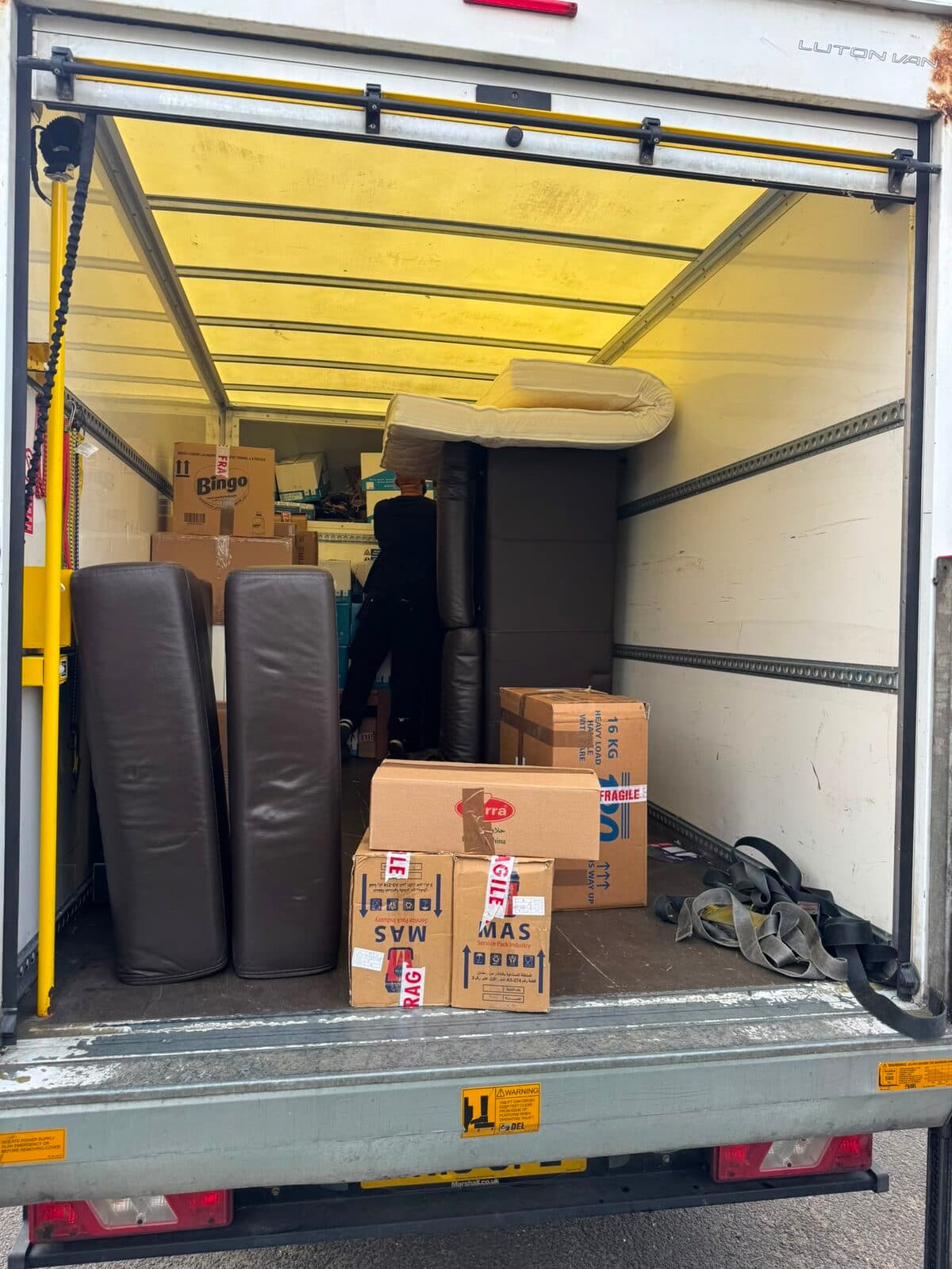 Luton van being loaded with sofa sections and fragile-marked boxes during the Uxbridge to Enfield move