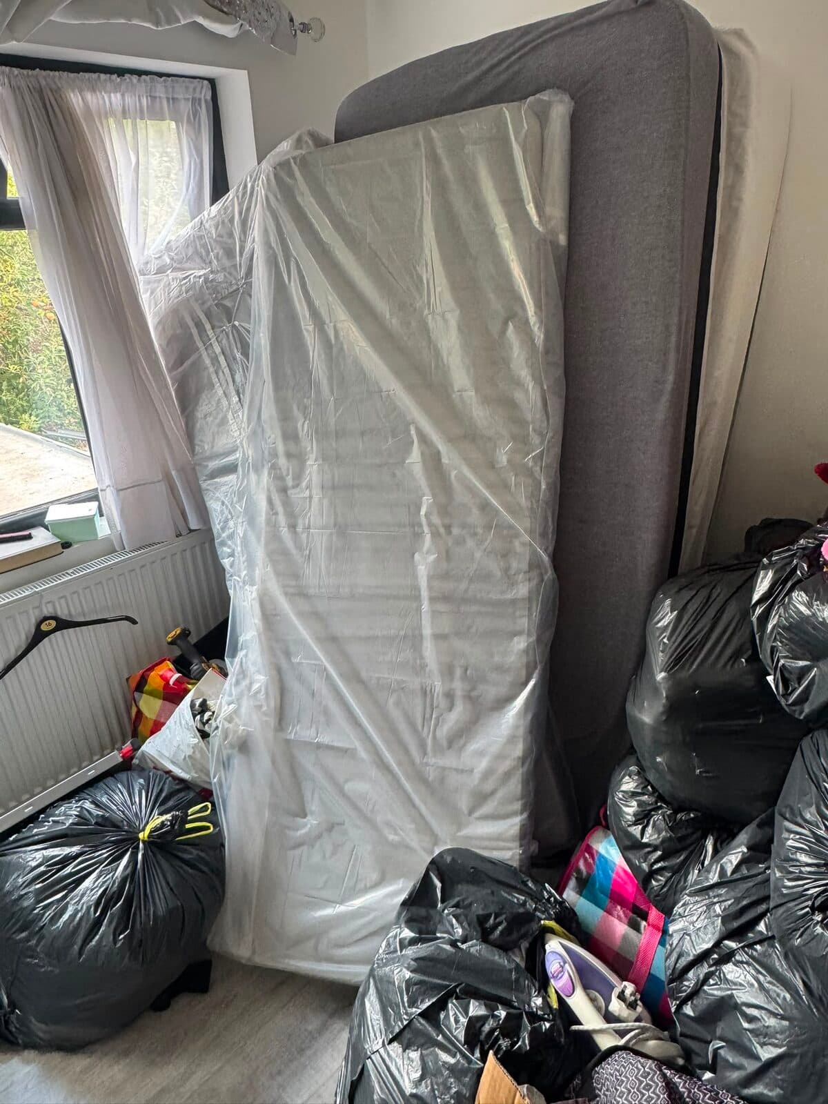 Mattress wrapped in protective covering ready for transport from Uxbridge to Enfield
