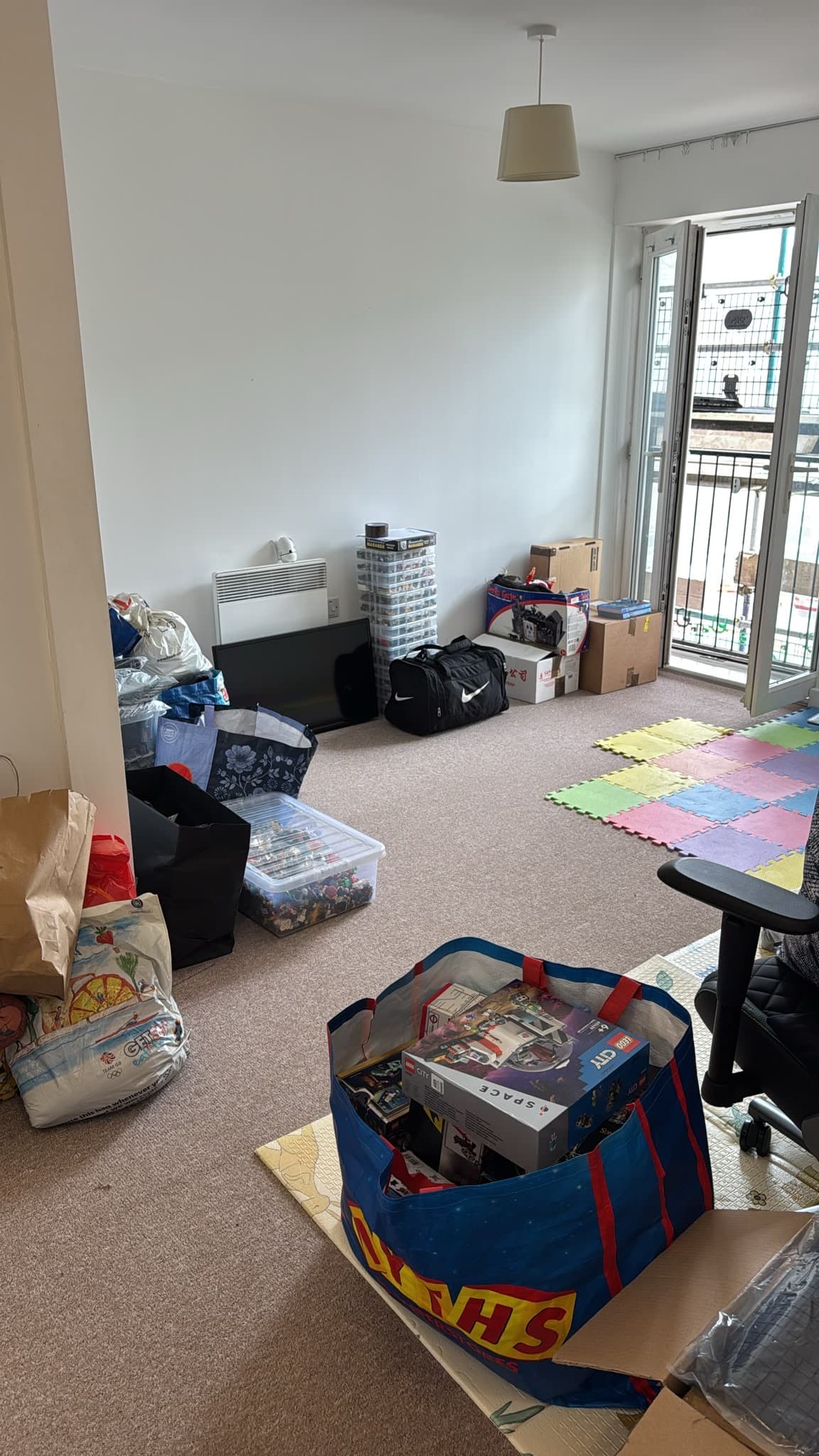 Living room belongings staged for collection during the Stevenage flat move