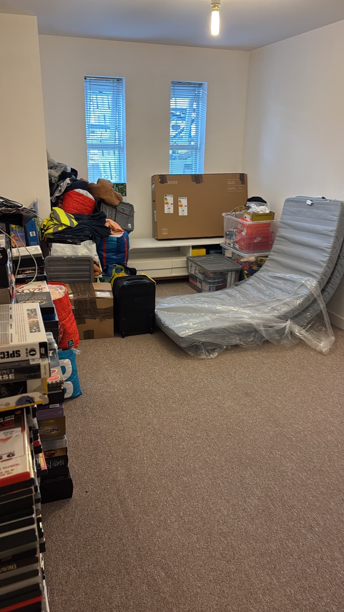 Bedroom with boxed TV, mattress and packed items ready for the Stevenage move