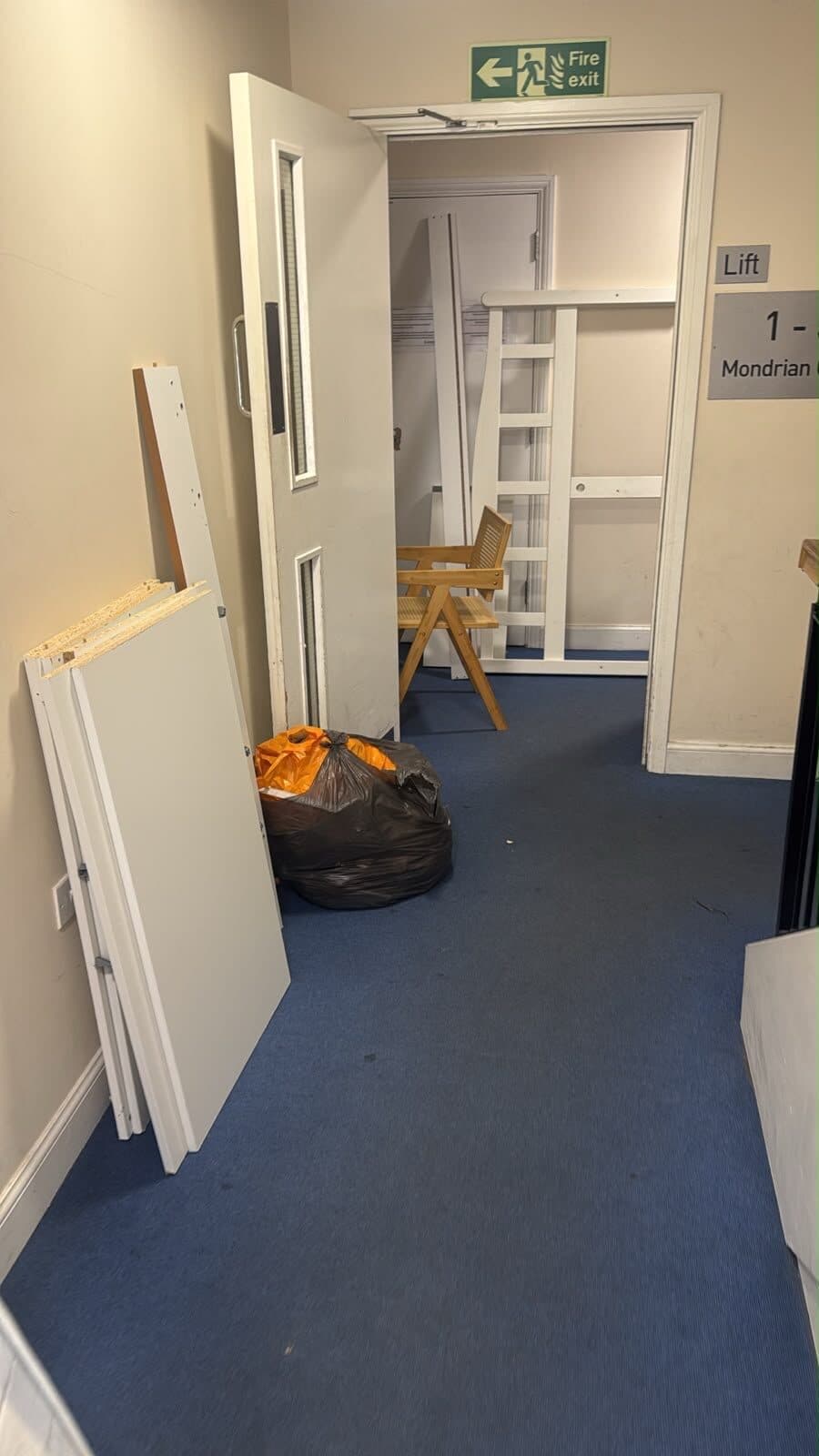 Items staged in the corridor ahead of the lift down from the third floor in Harrow