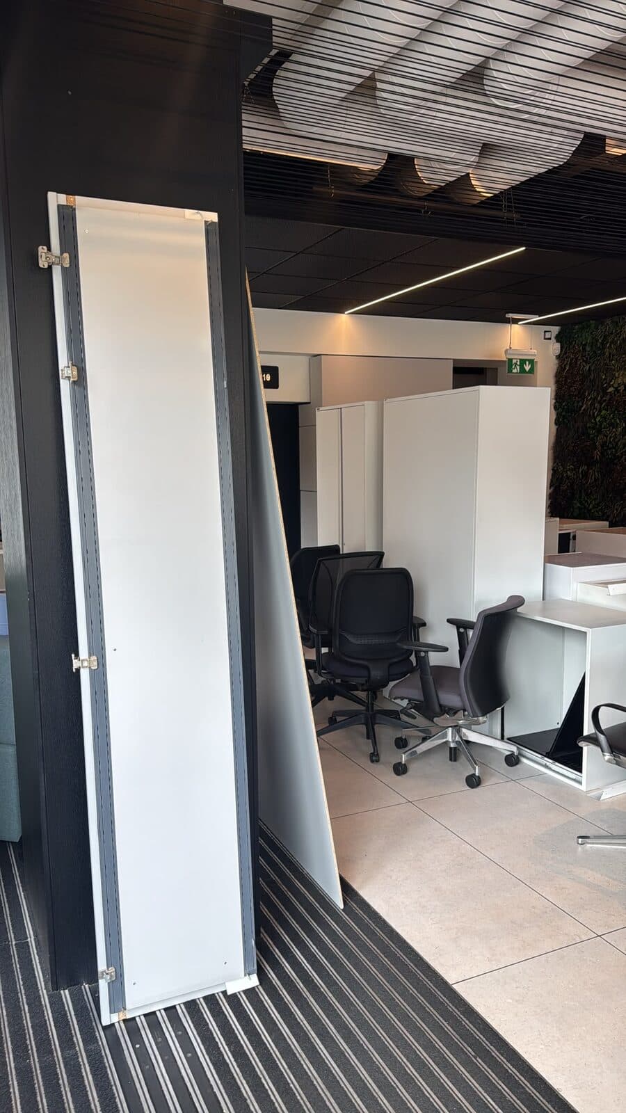 Glass-partitioned office space with desks and chairs set out after the Houghton Regis installation