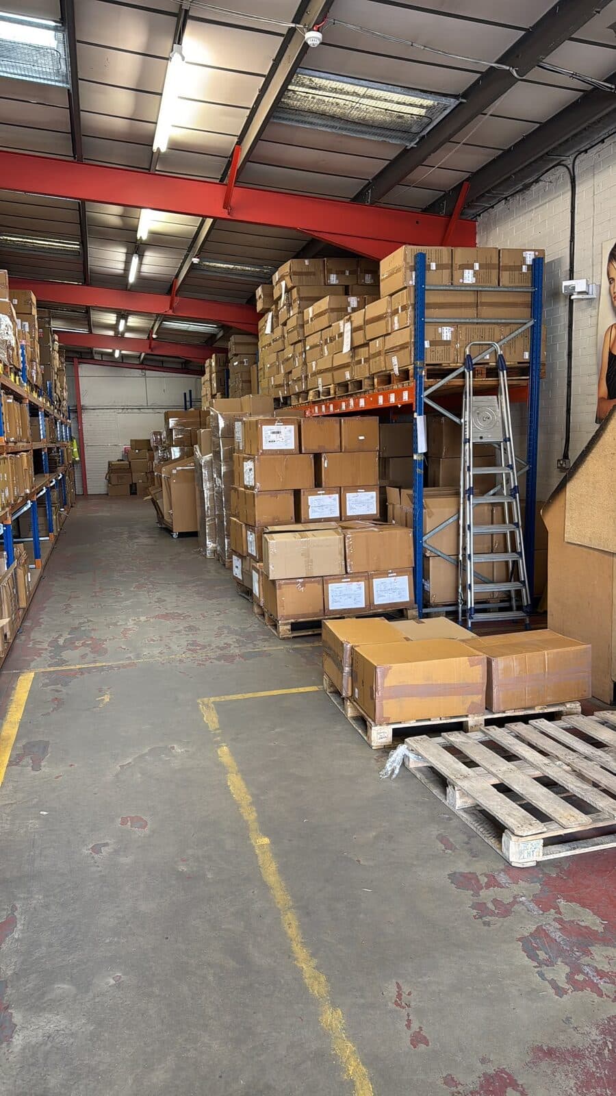 Customer boxes stacked on pallets and racked in a secure storage warehouse