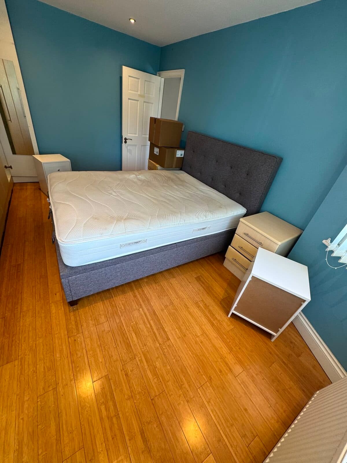 Divan bed and bedside units prepared for dismantling during the Richmond house move