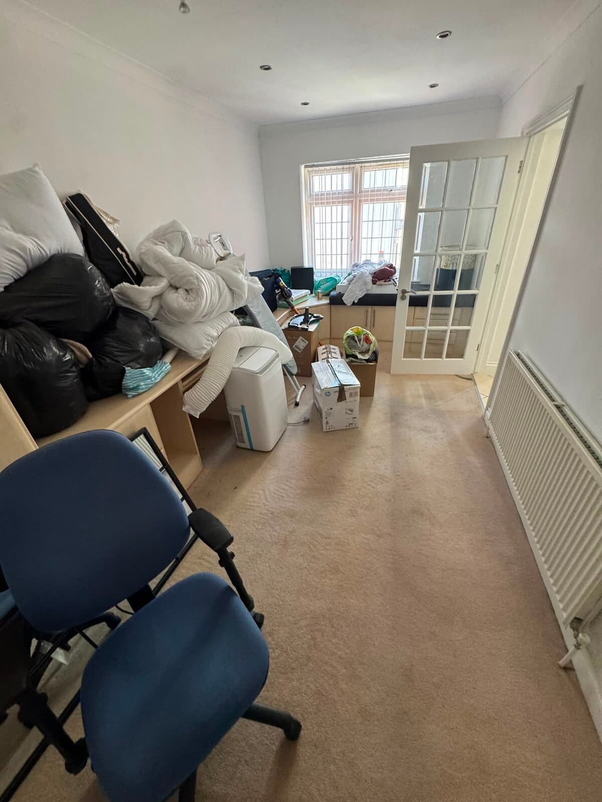 Bedding, boxes and office chairs staged ready to load during the Stanmore to Harrow move