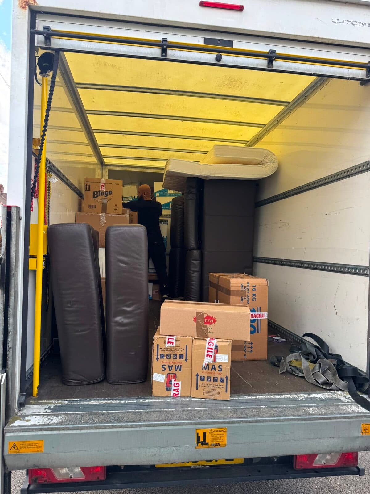 Boxes packed, labelled and stacked inside a RayMovals van alongside protected furniture