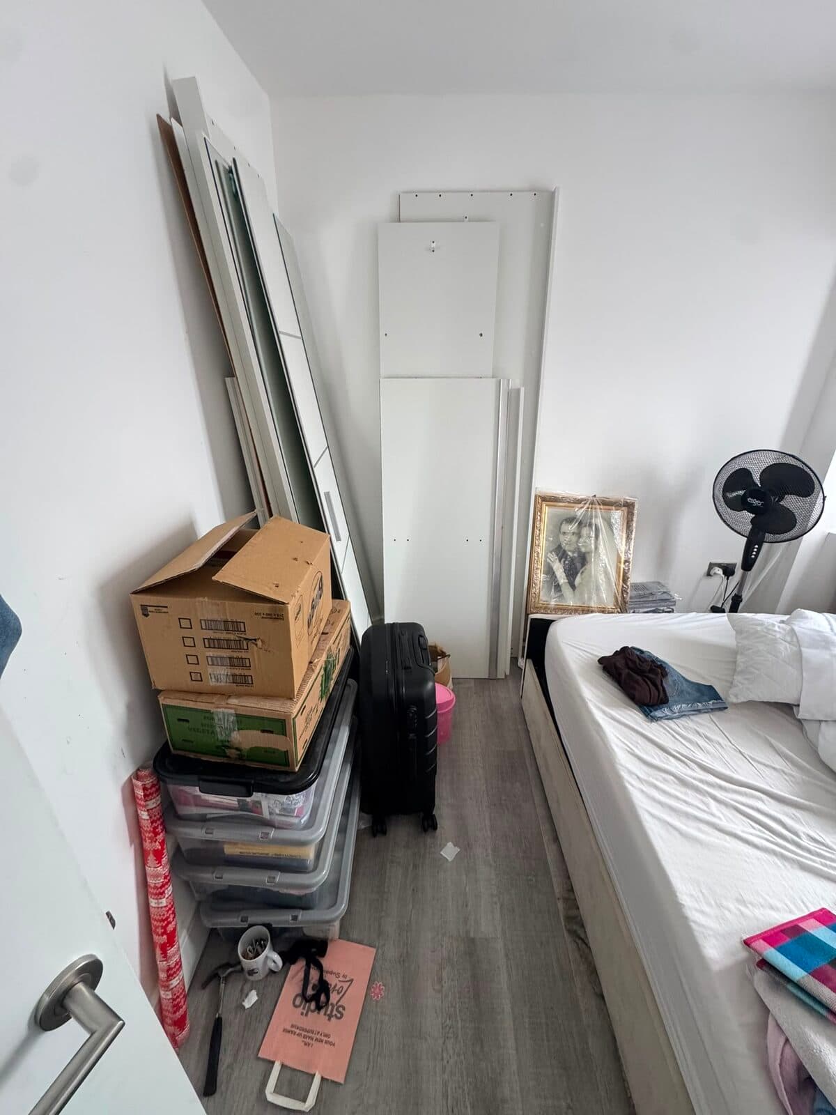Dismantled wardrobe panels and packed boxes stacked ready for loading at the Uxbridge house