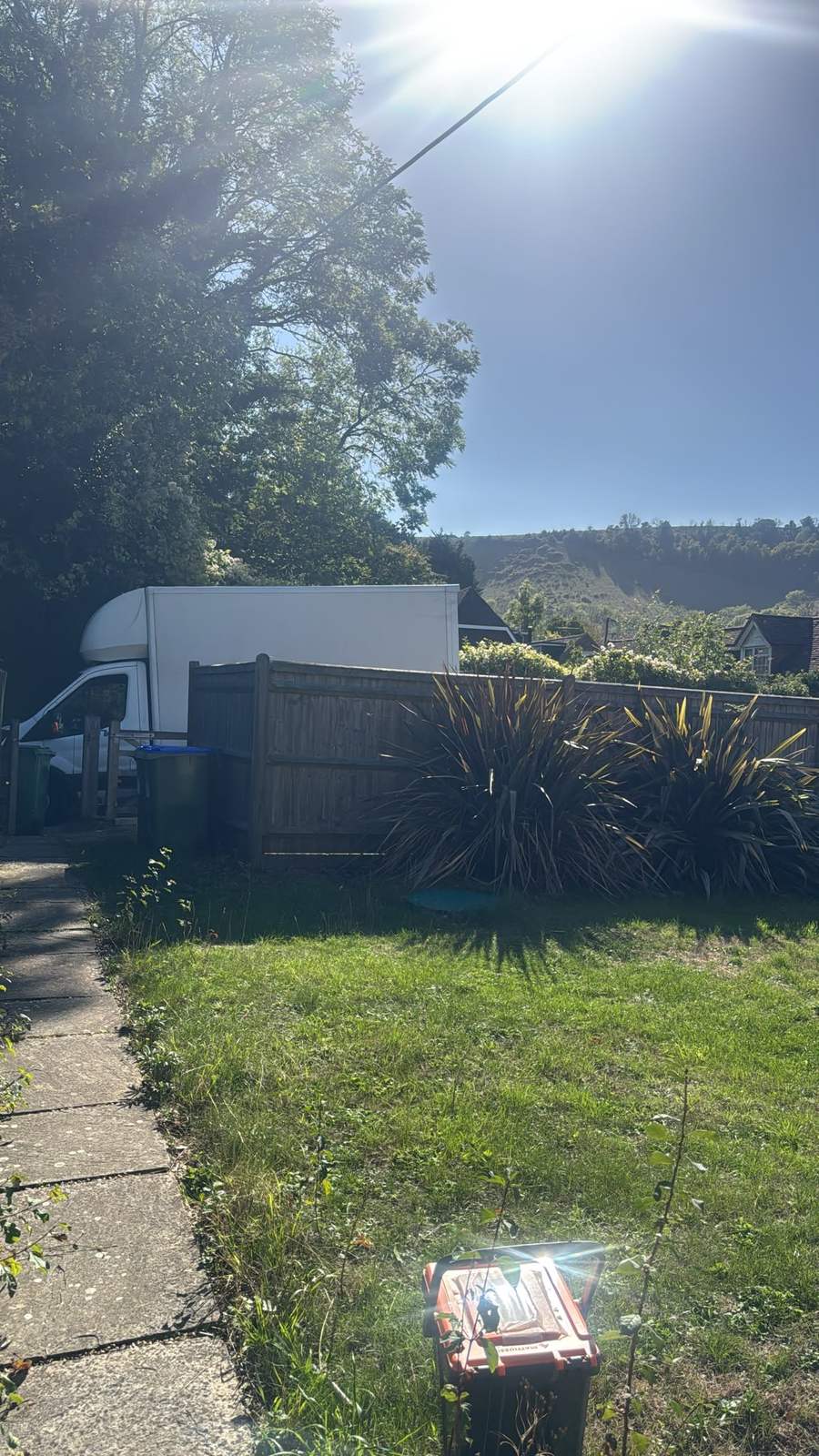 Removal van parked alongside the fence line at the collection address