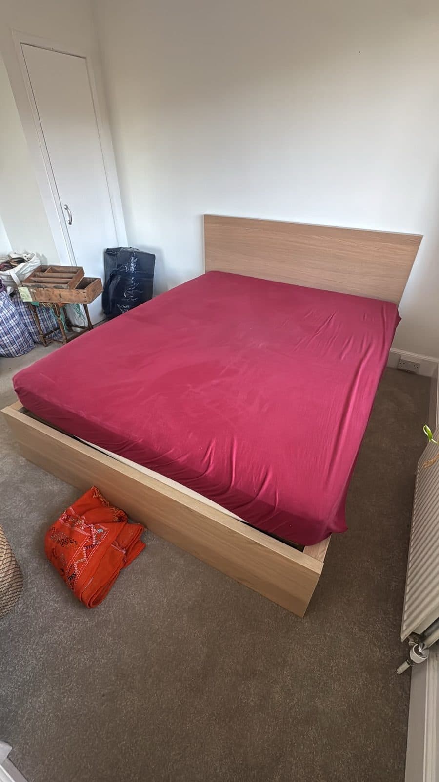 Double bed frame and mattress in a bedroom before dismantling on the Leighton Buzzard to Sussex move