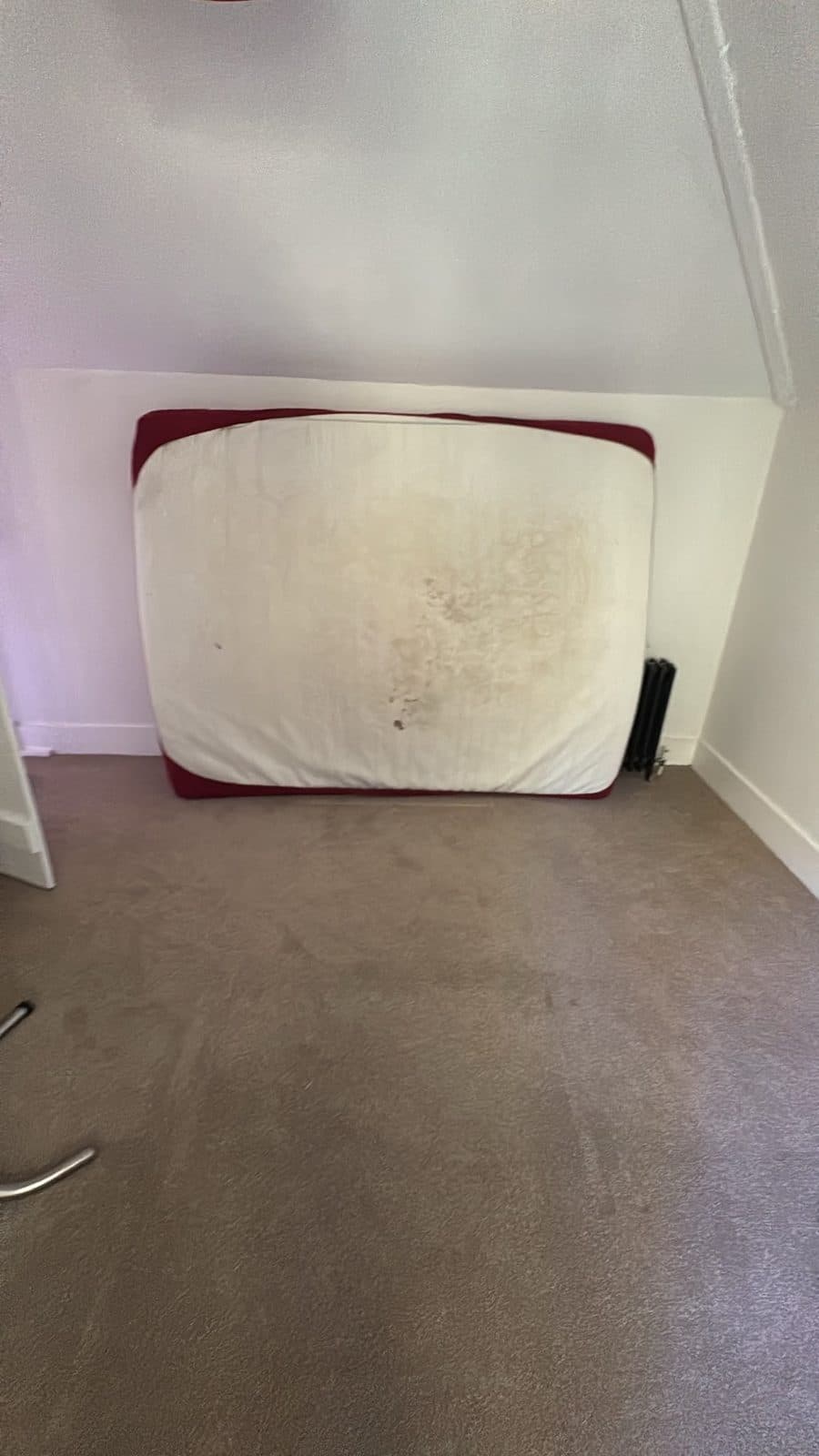 Mattress stood against the wall of an emptied bedroom once the frame was dismantled