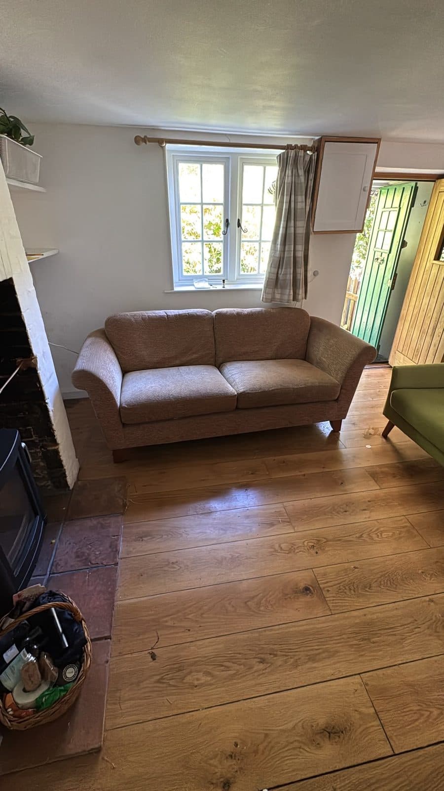 Second sofa placed in position in the beamed living room after delivery