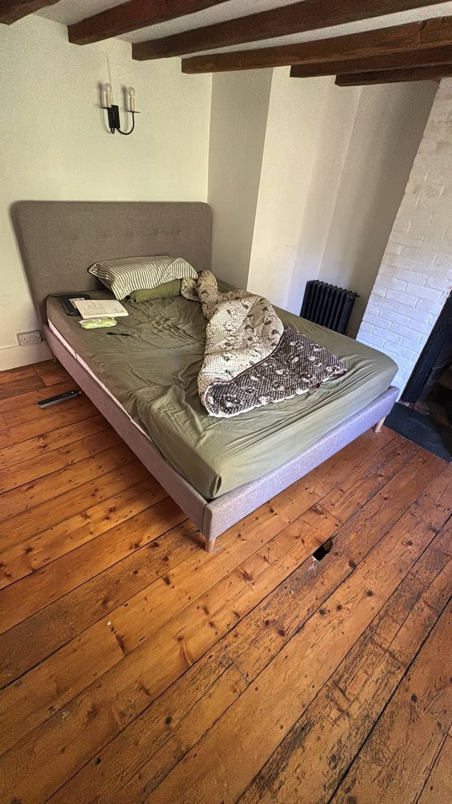 Bed rebuilt in a beamed bedroom with wooden flooring at the Sussex destination