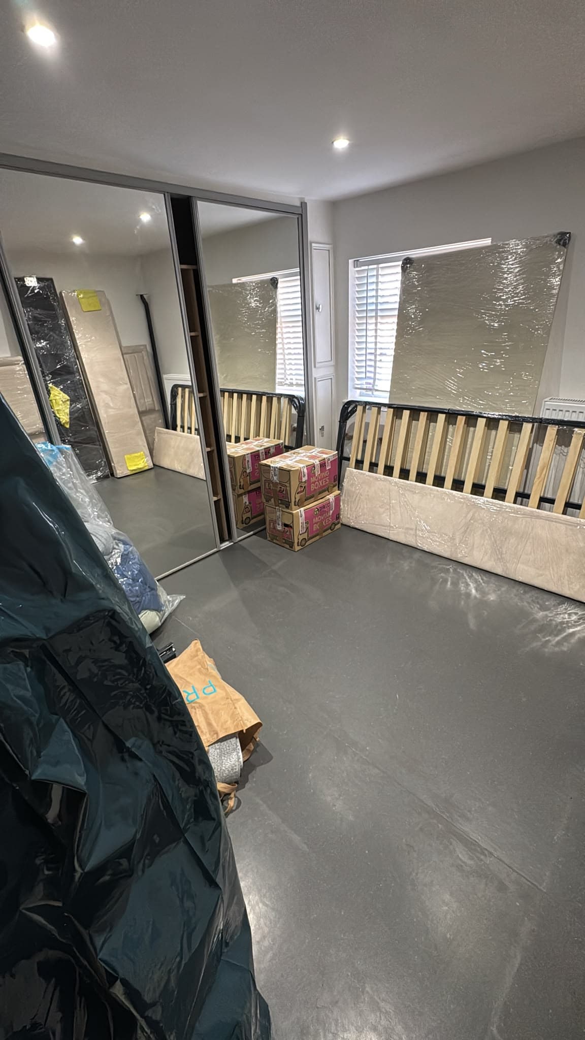 Bed frames dismantled, mattresses wrapped and wardrobe doors protected ready for the move to Bedford