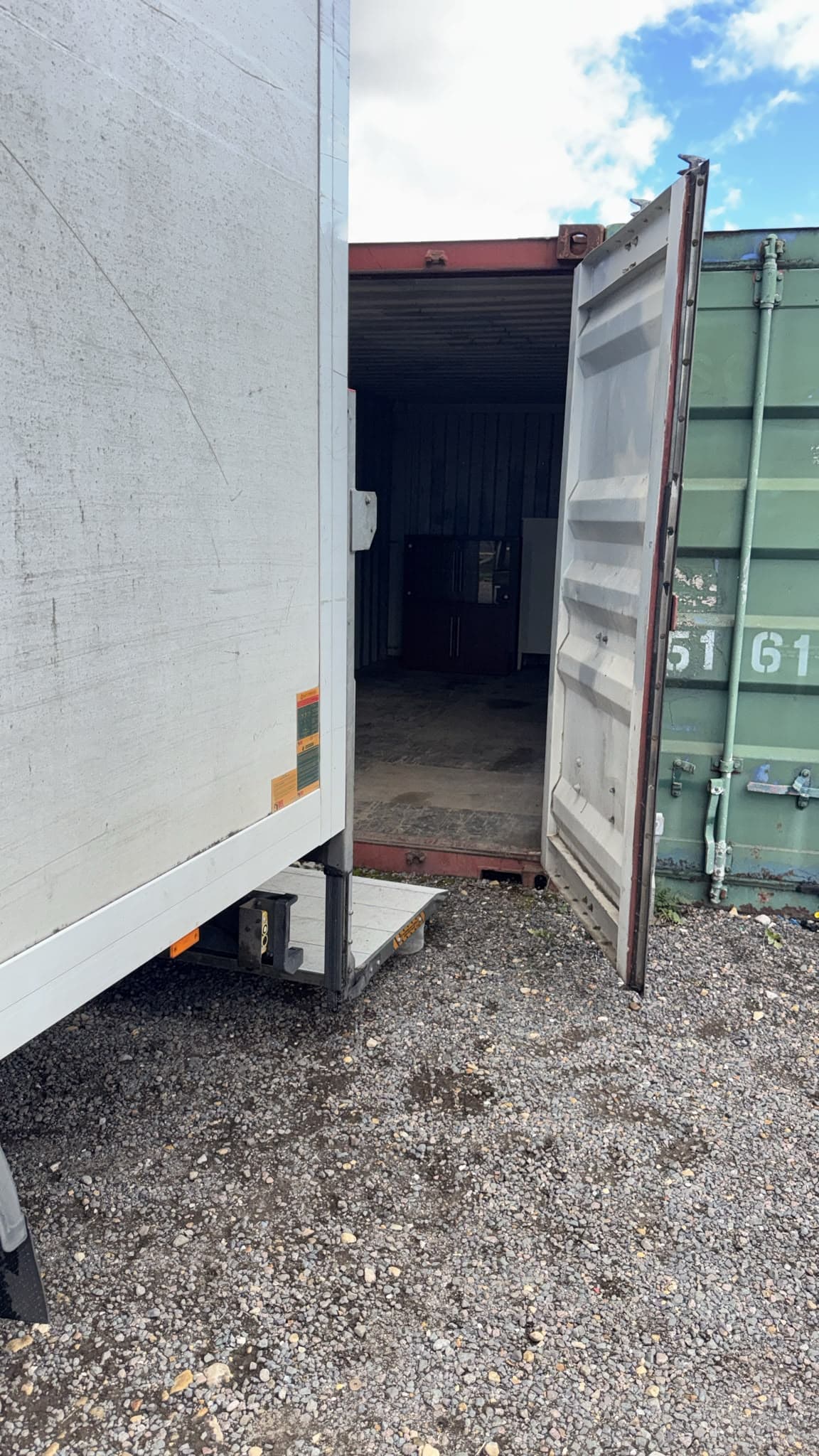 Luton van tail lift backed up to the storage container doors in Gamlingay ready to unload