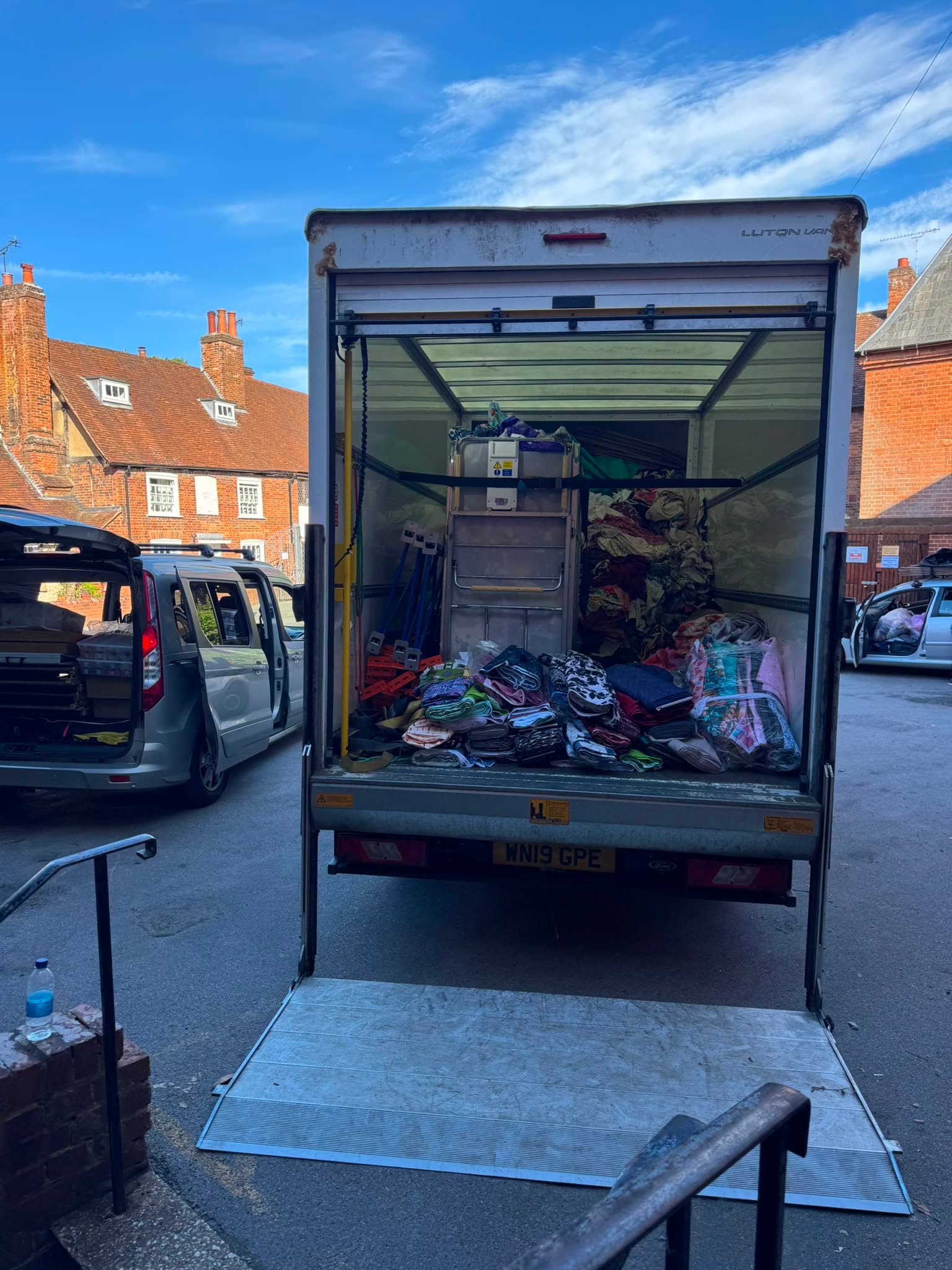 RayMovals Luton removal van with tail-lift lowered outside a Hertfordshire market town